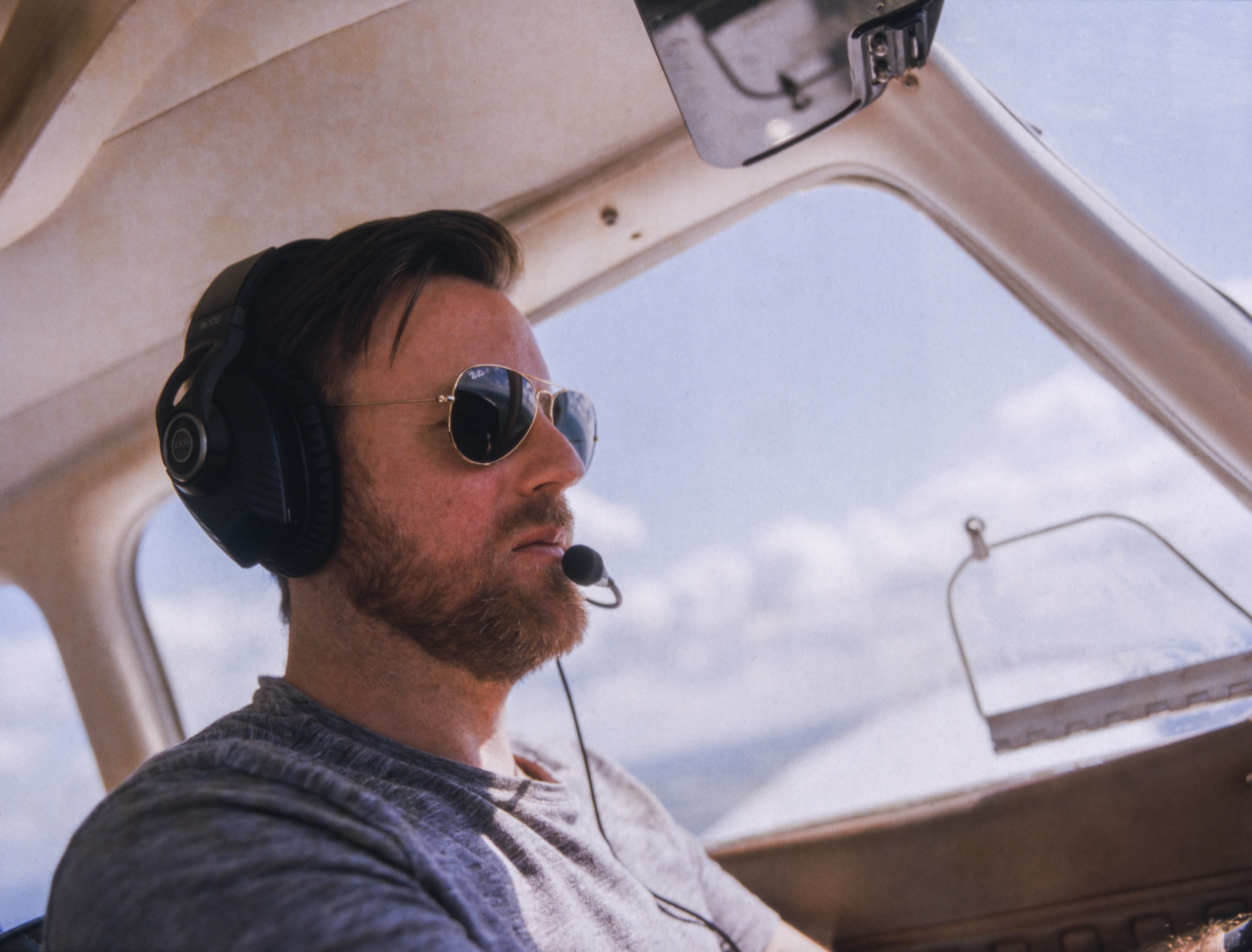 Middle aged man flying a light plane