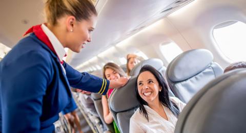 Flight attendant speaking with the passenger