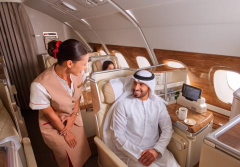 emirates cabin crew speaking to a passenger