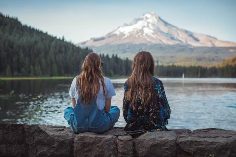 two girls looking at a mountain